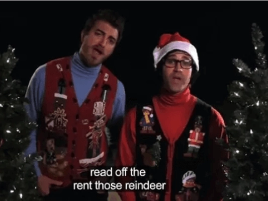 Two men singing "Rudolph the Red Nose Reindeer" with subtitles on screen saying "read off the rent those reindeer".