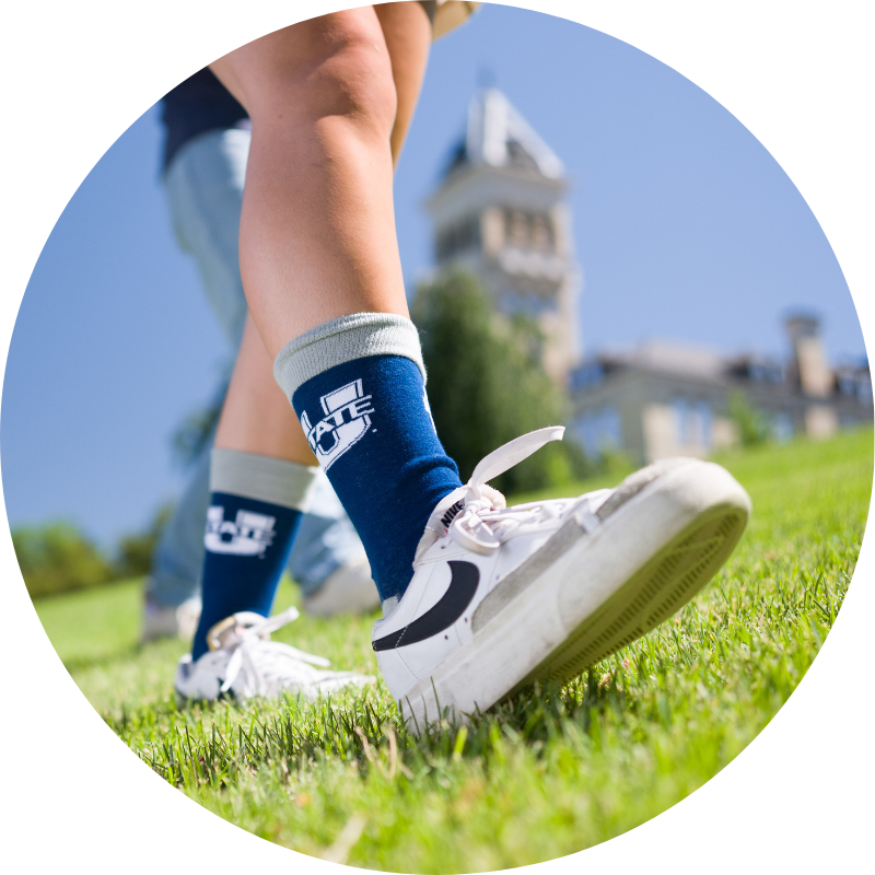 Student's shoes and wearing aggie socks