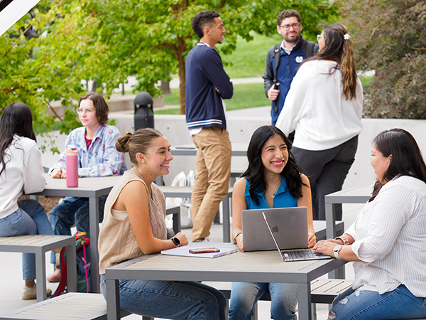 Students sitting around a table outside