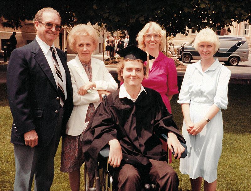 Older color photo of people standing in front of Jim Minkler 