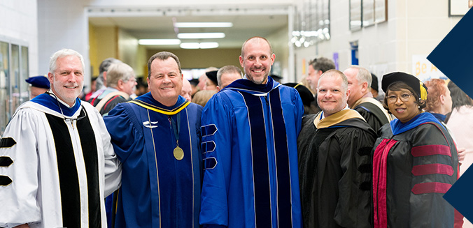 People standing in graduation attire