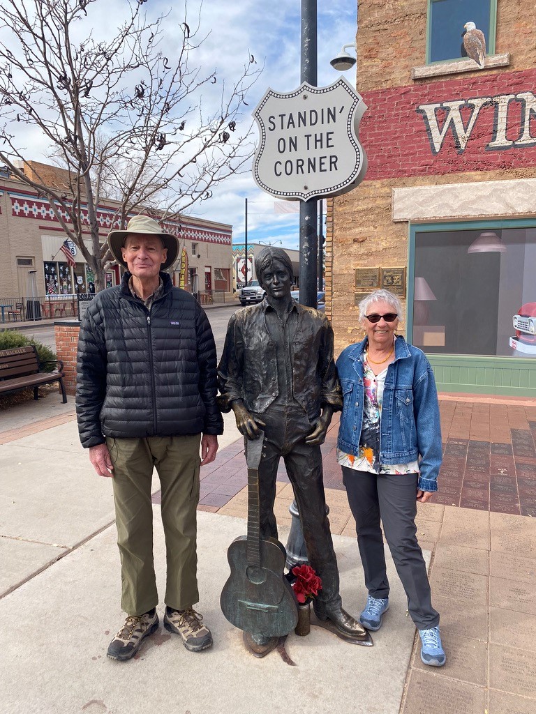 Randy Rhodes with his wife, Heidi, posing in Winslow, Arizona, with a statue of Glenn Frey from the classic rock band, the Eagles.