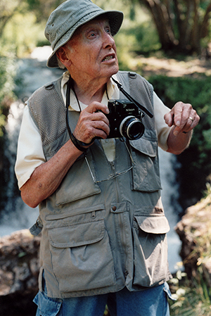 R.T. Clark in the forest with a camera