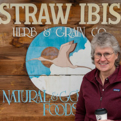 photo of woman in front of store sign