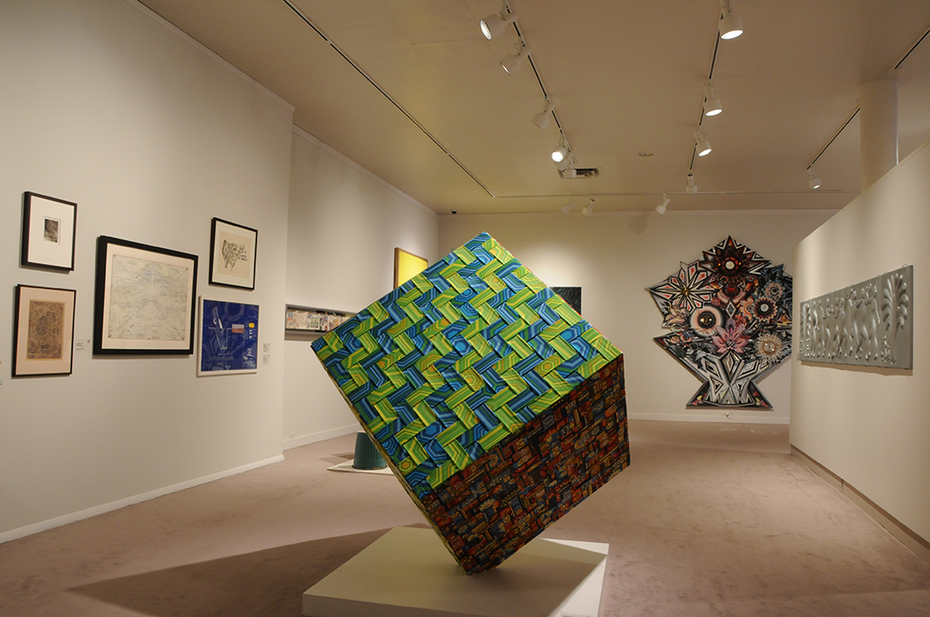 A 3-D cube sculpture balanced on a corner