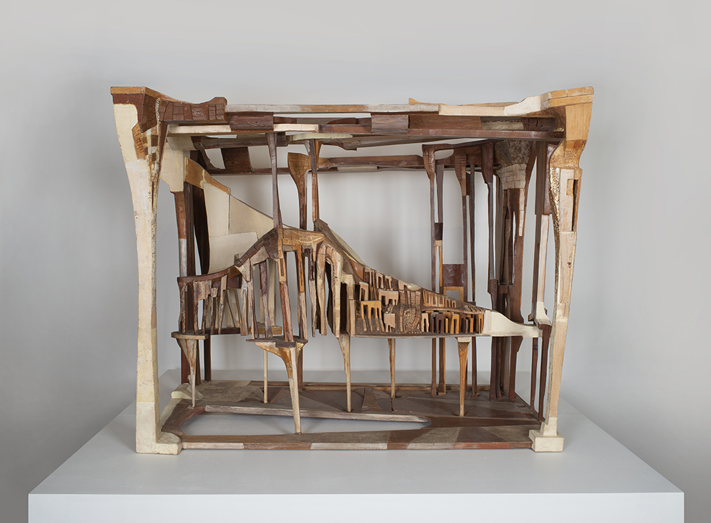 Glued wooden sculpture with the focal structure supported in the middle of a cubical frame