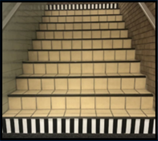 Stairway with black and white strips on side on top and bottom stair.