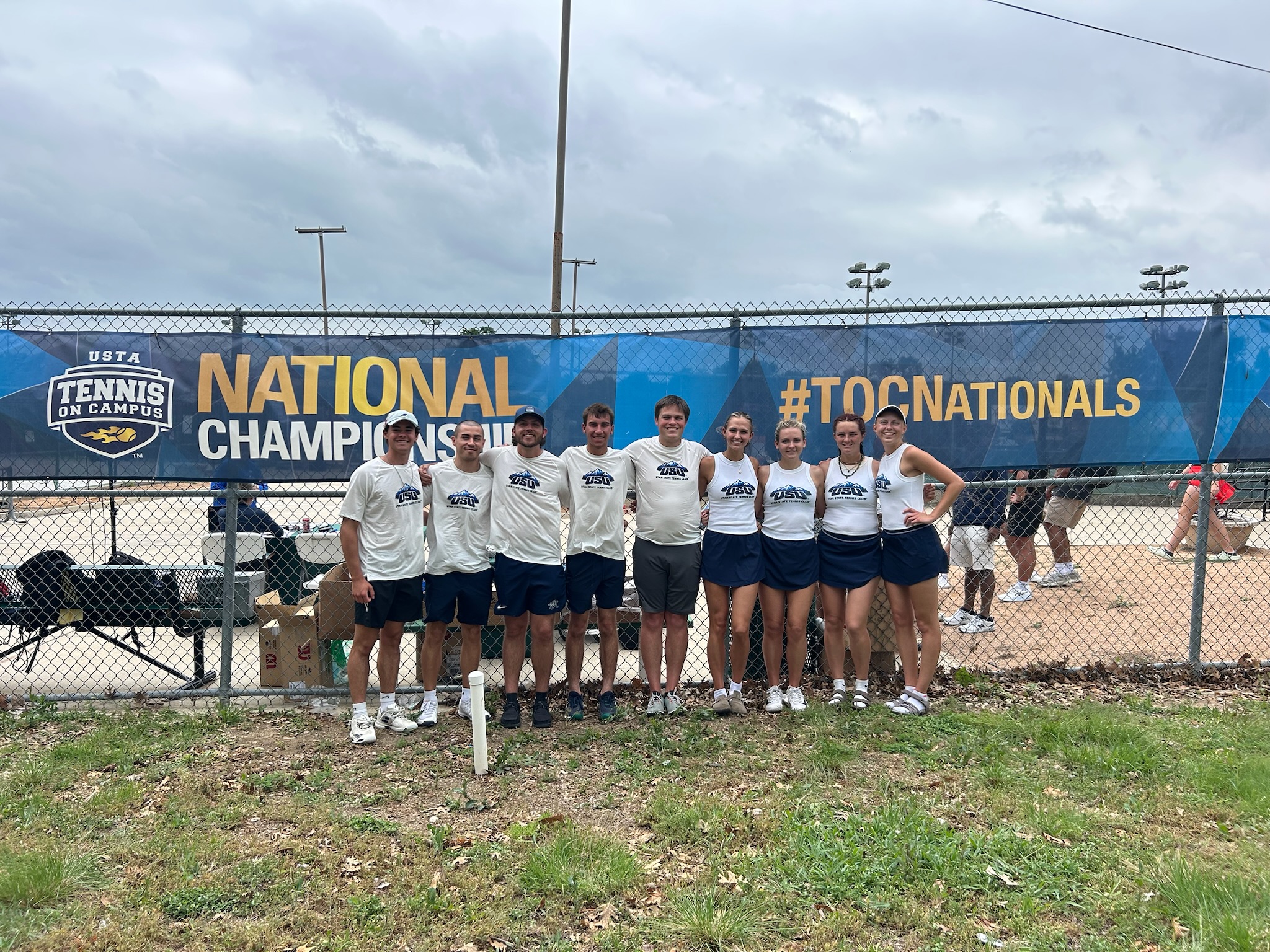 group photo of a club tennis team after a tournament