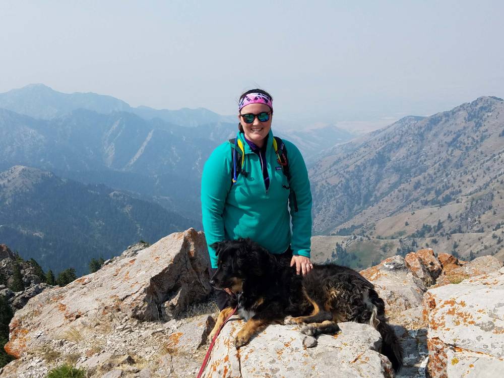 Amanda Bray on a mountain with a dog