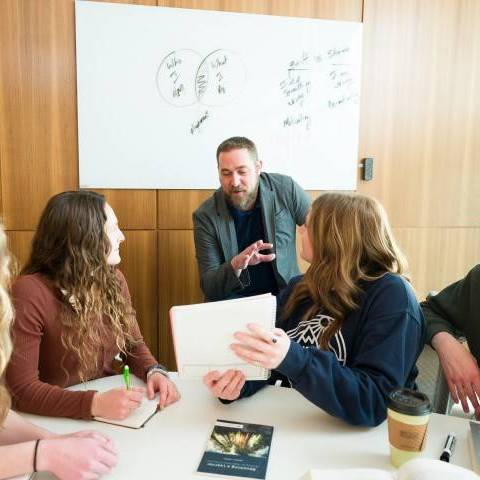 A professor explaining a topic to two students