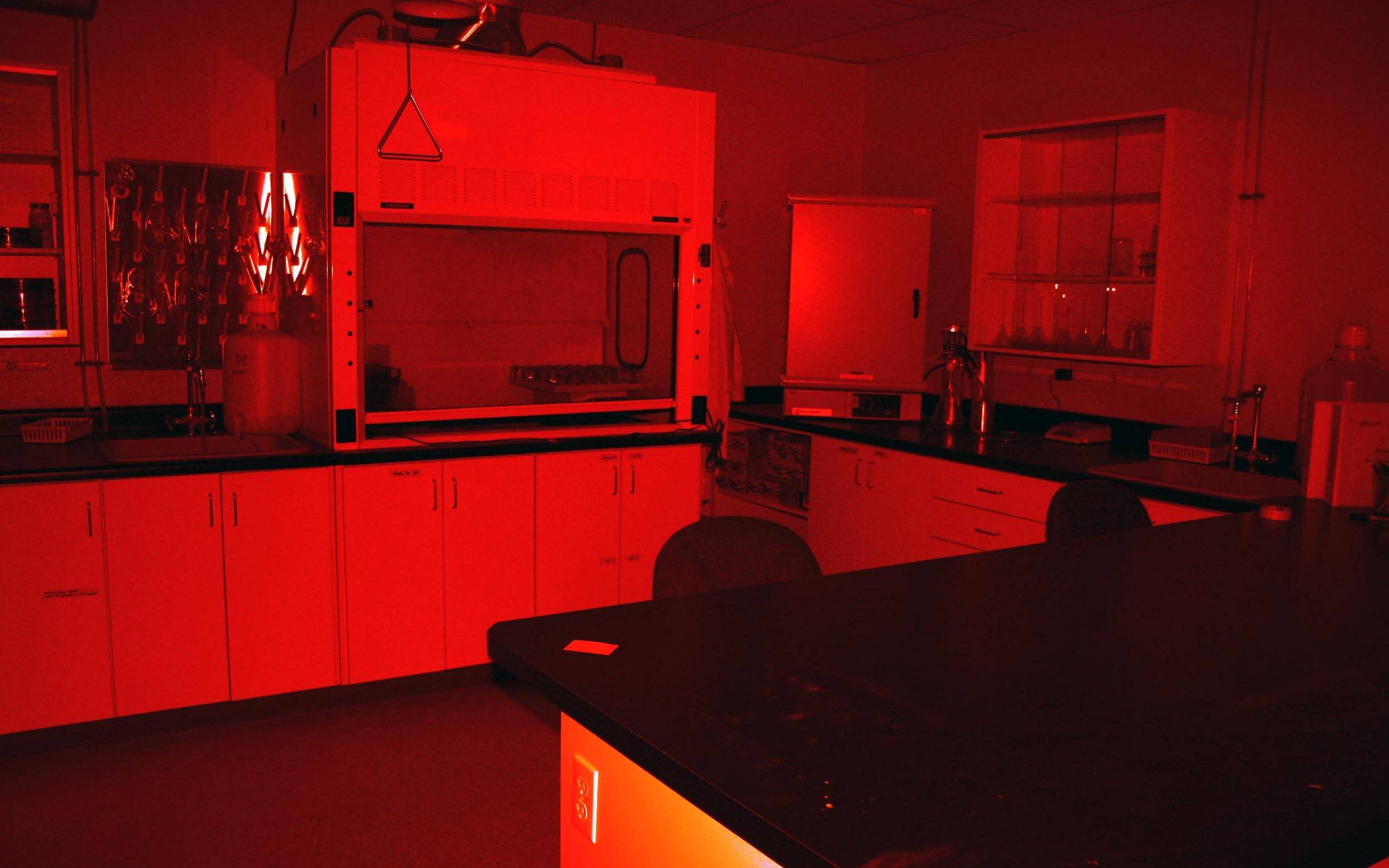 a lab with white counters and equipment