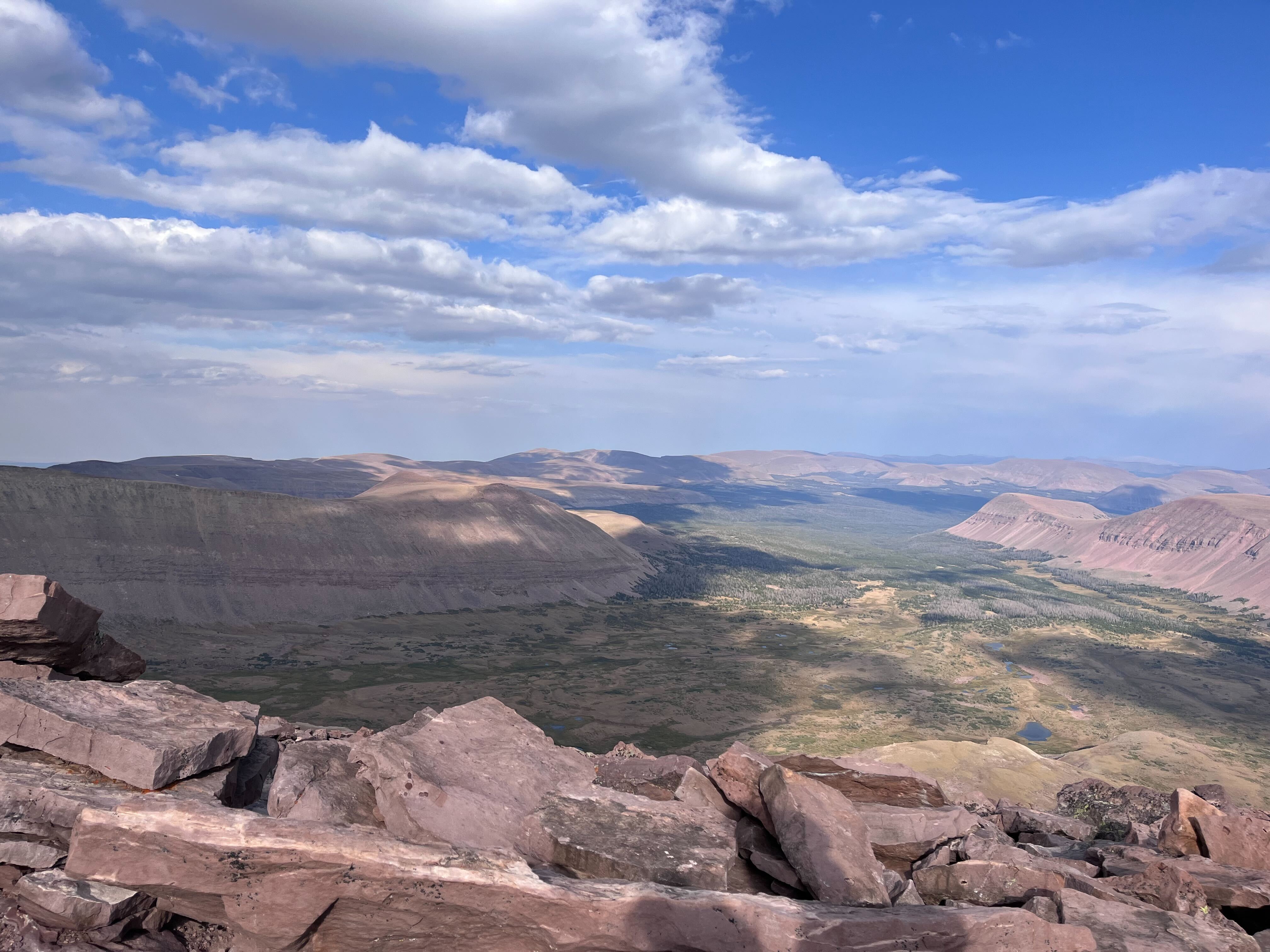 An aerial view of a rocky, flat mountain valley