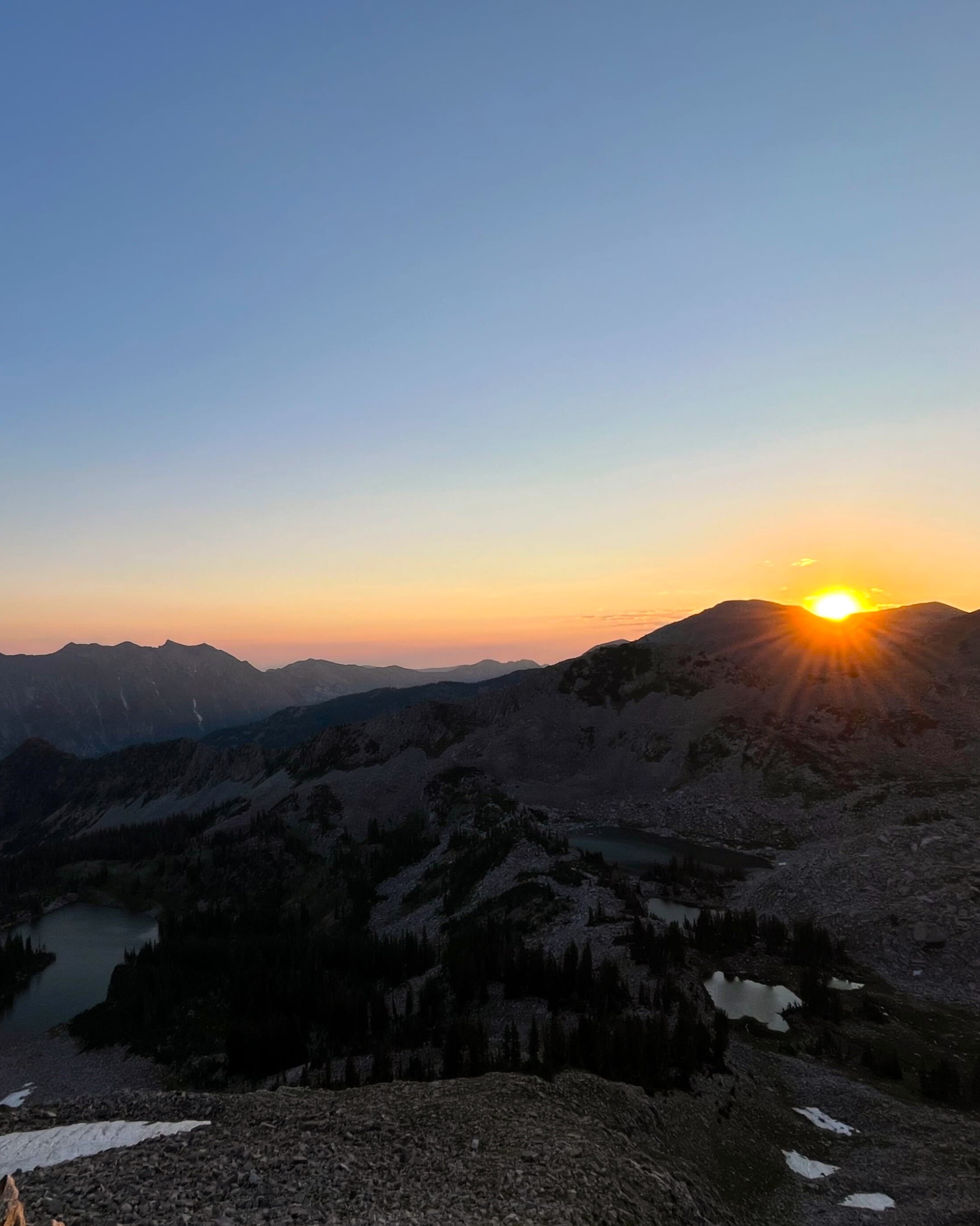A sunset over mountains ringing a valley