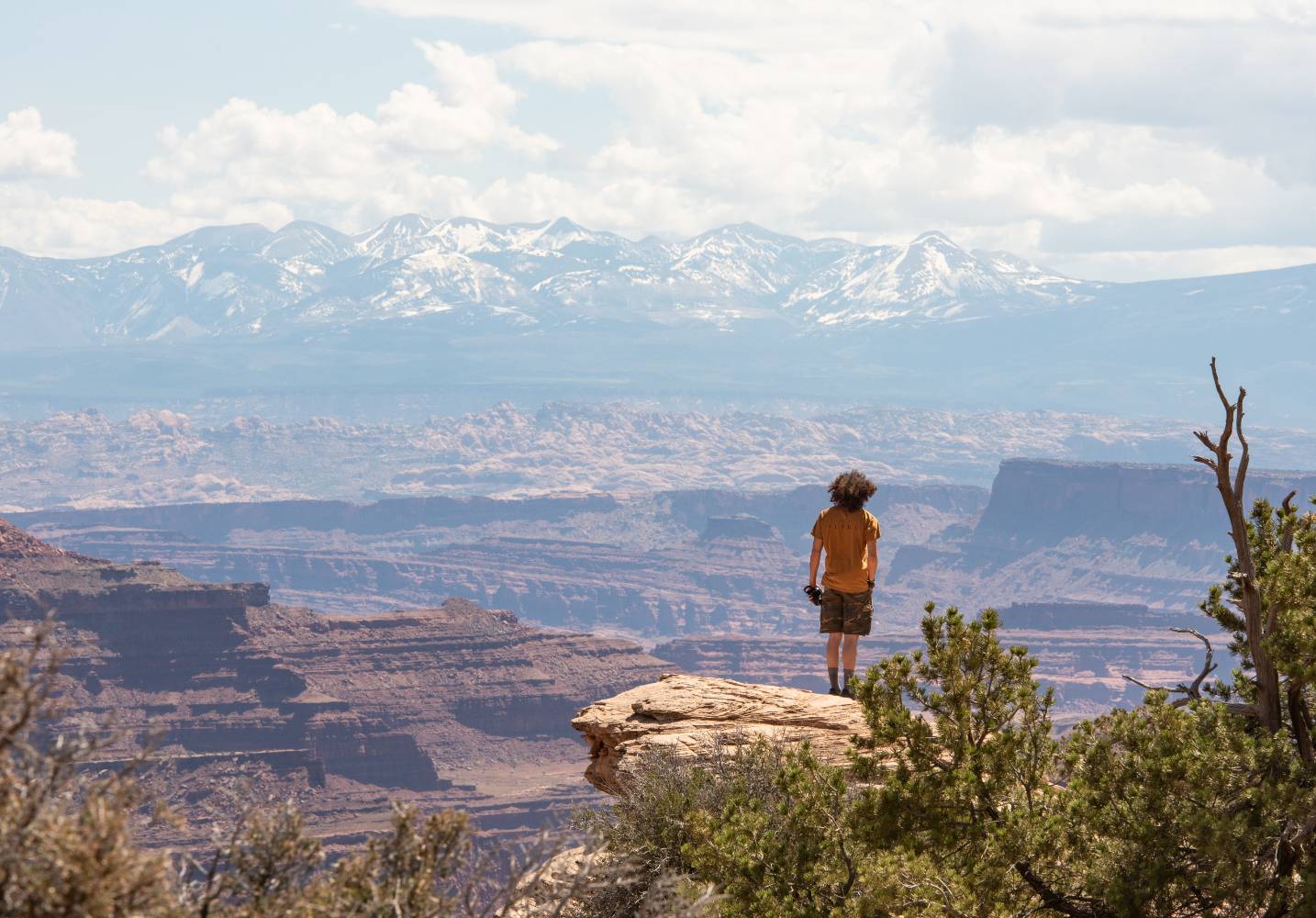 A hiker stands at White Rim Overlook in Canyonlands National park