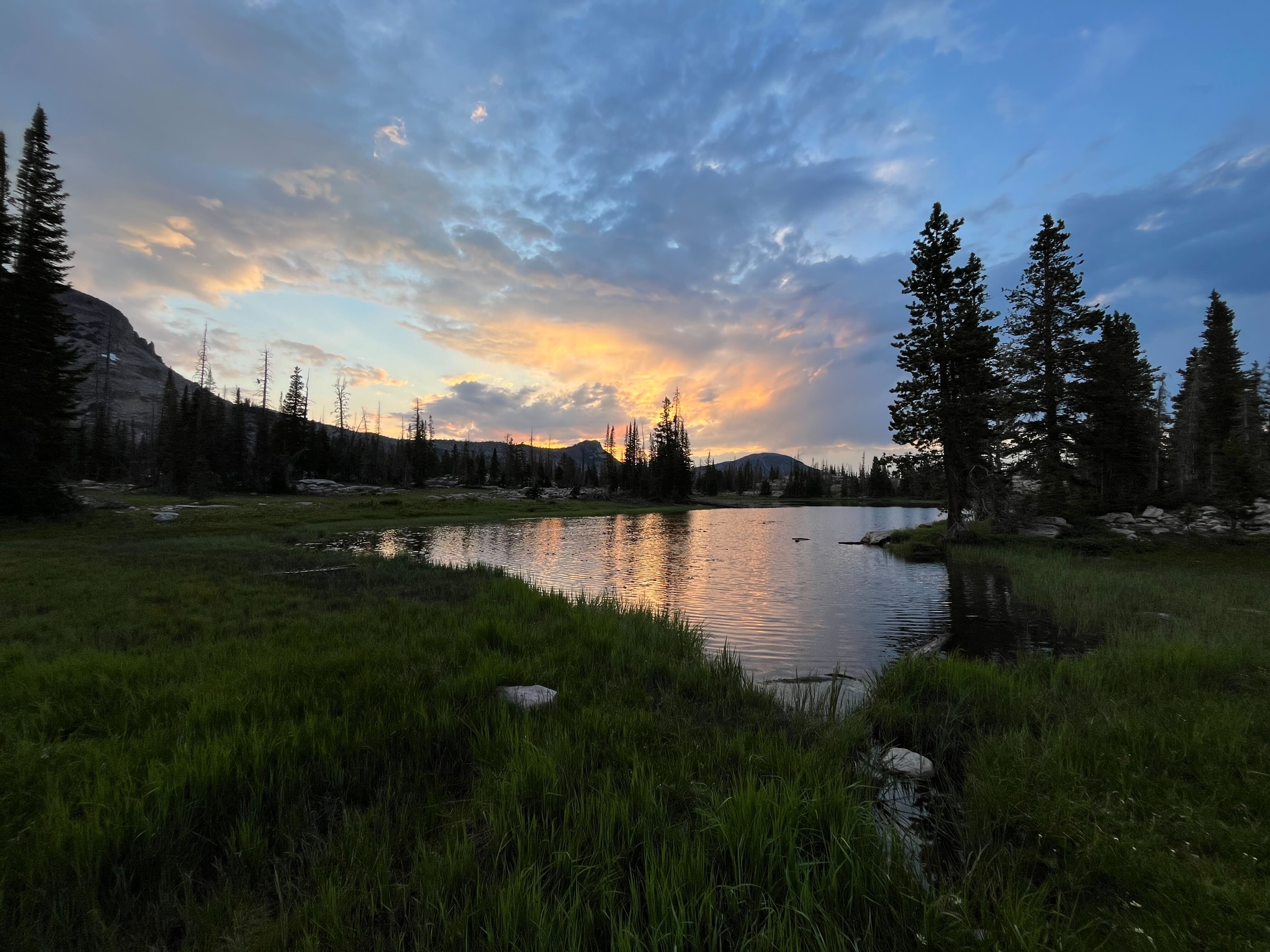 A sunset over a mountain lake