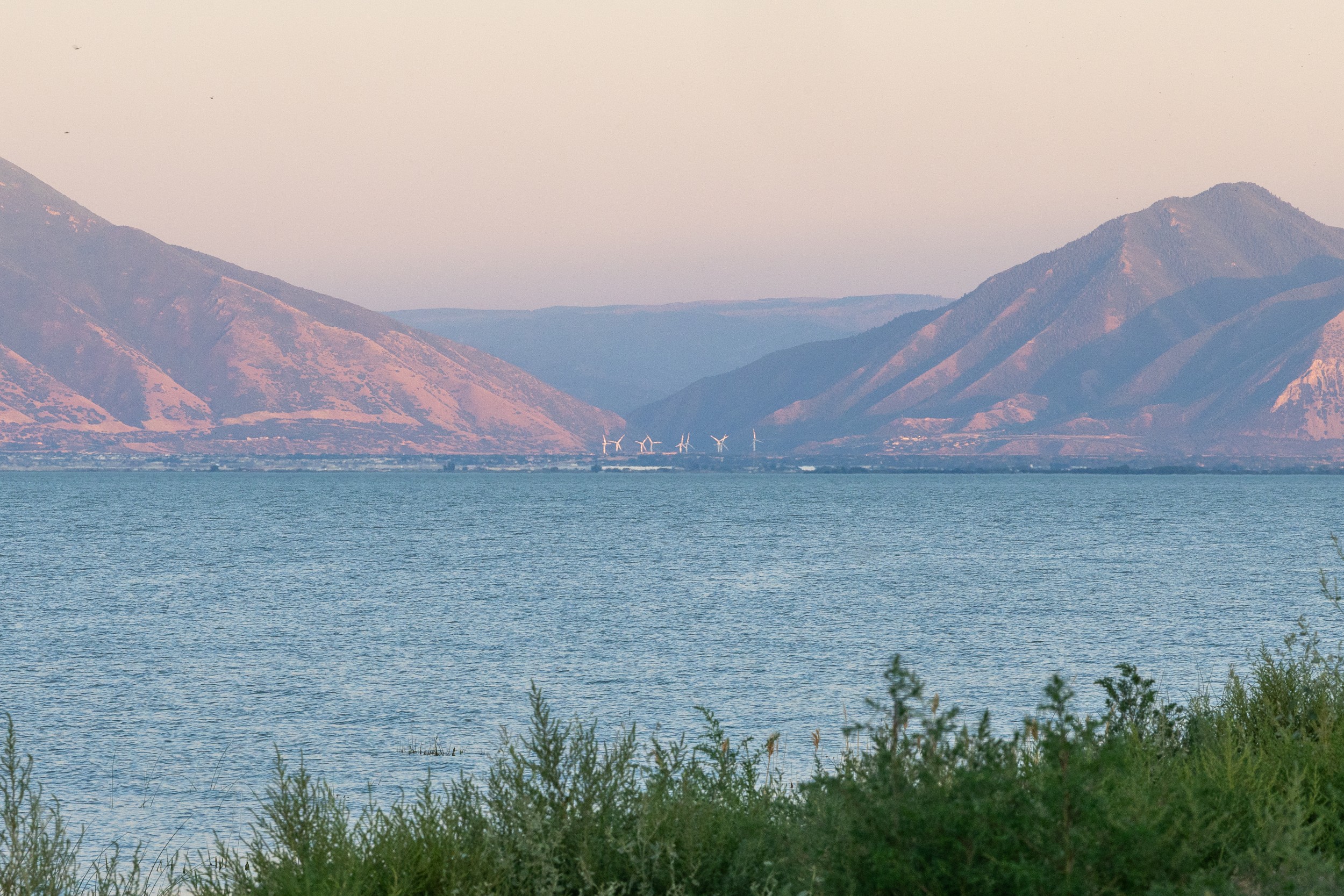 A lake with wind turbines visible on the far side