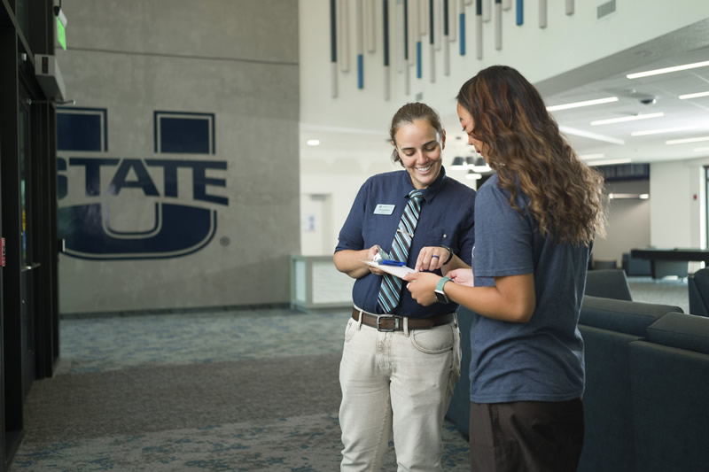 staff checking in a student in the office