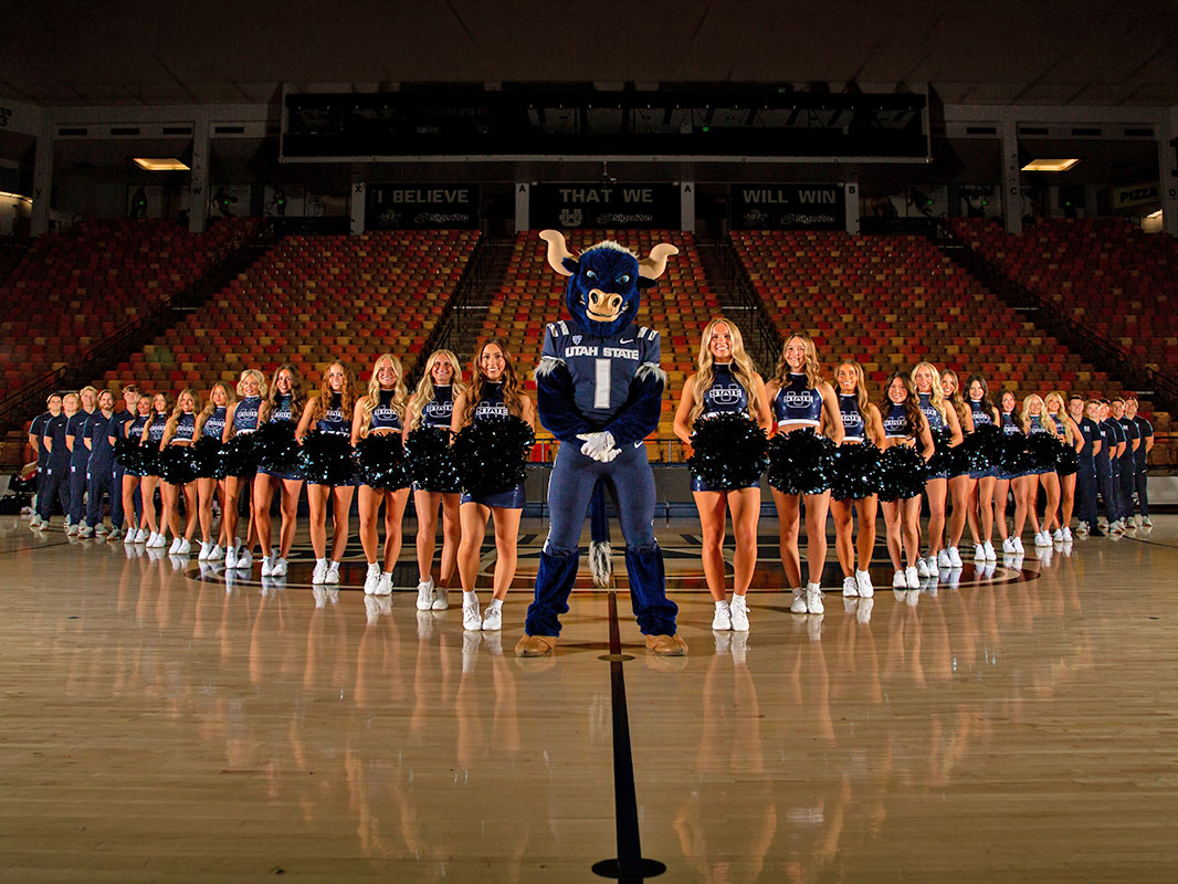 A large group of Utah State University aggiettes, cheerleaders, and male cheer team members pose with Big Blue, the mascot. This image links to the USU Spirit Squad page.