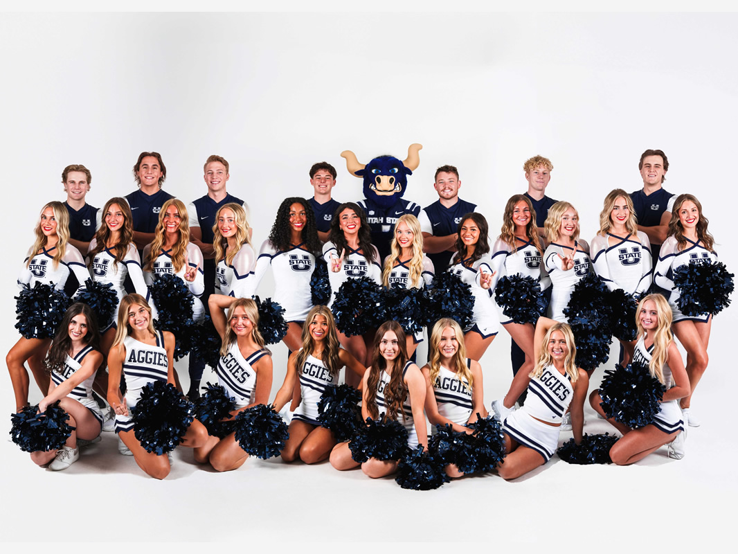 A large group of Utah State University cheerleaders and male cheer team members pose with Big Blue, the mascot. This image links to the USU Spirit Squad page.
