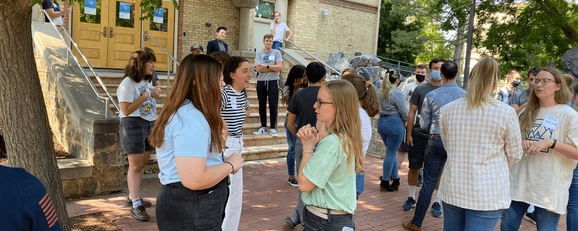 CAI students talk with each other during a class break on the USU campus.