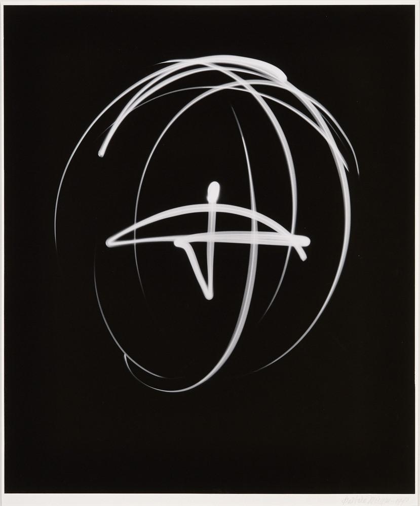 White orbit lines around a central white shape on black