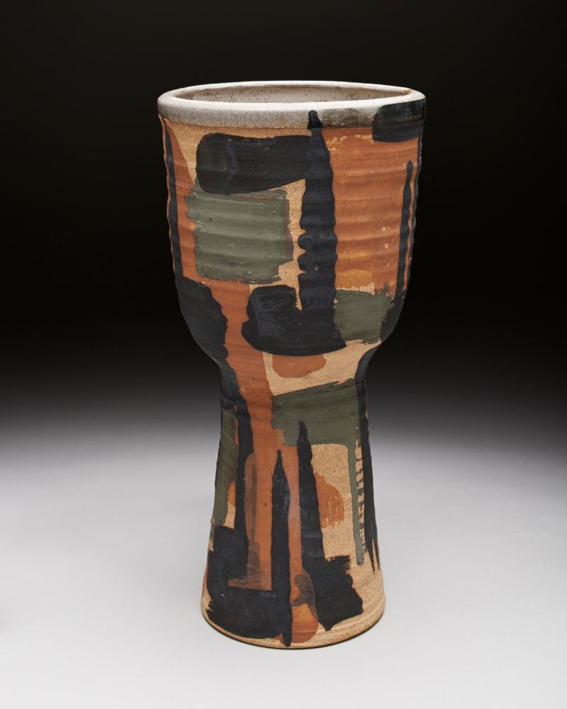Stoneware cup with black, green, and orange over lapping shapes