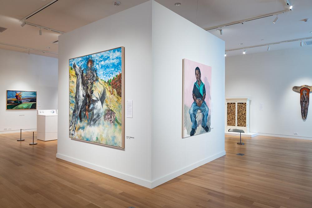 A central wall displaying a cowboy and sitting man art pieces