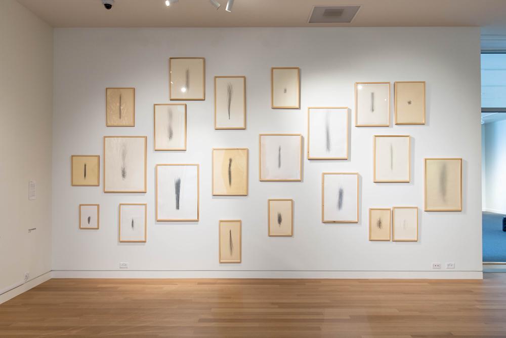 A gallery wall of similar off white framed art pieces