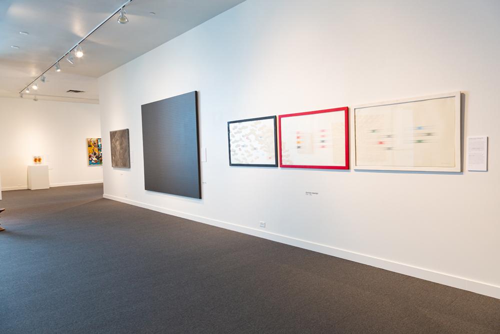 5 framed art pieces hang on a white wall