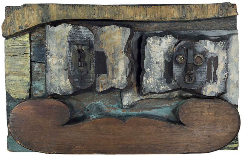 Two abstract faces with various shaped blocks of differing material surround them