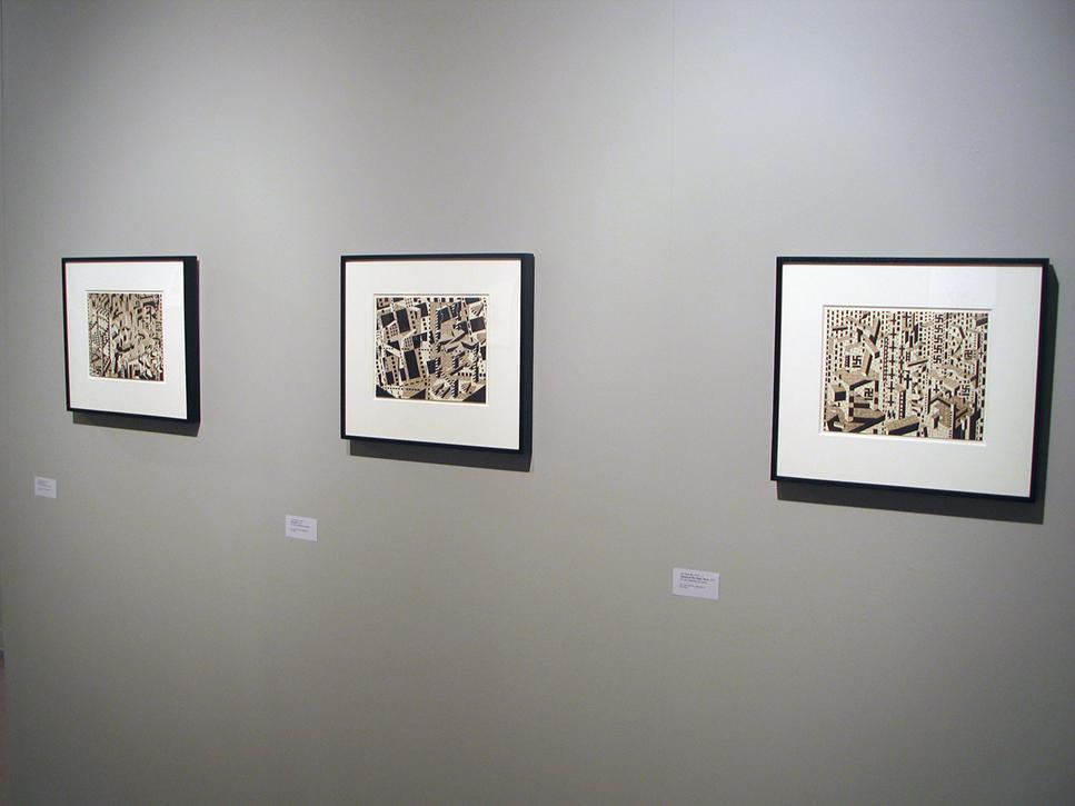 Three of the swastikas and cross art pieces hanging on the wall