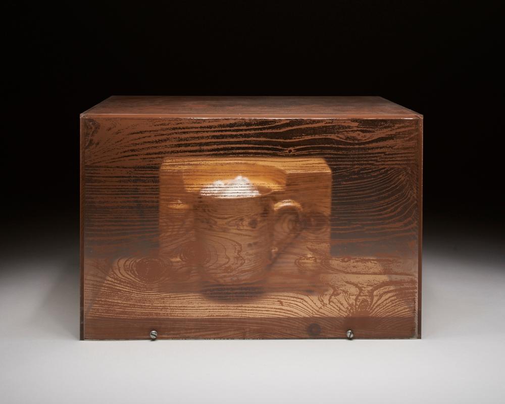 A transparent wood box with a mug inside