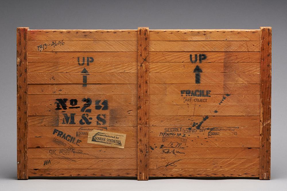 A crate with the words, "up", "fragile", and id numbers on it