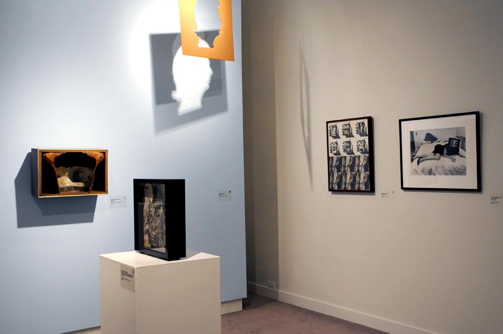 A corner of the exhibition displaying art on the wall and table
