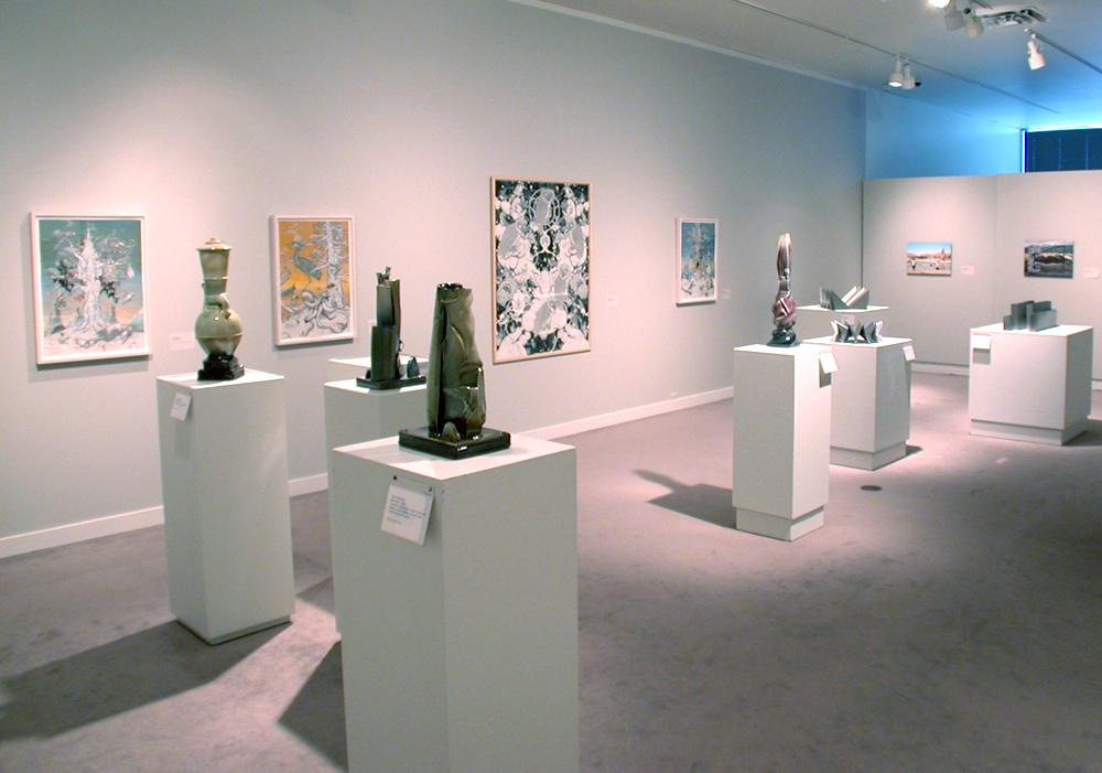 Vase like sculptures on white tables