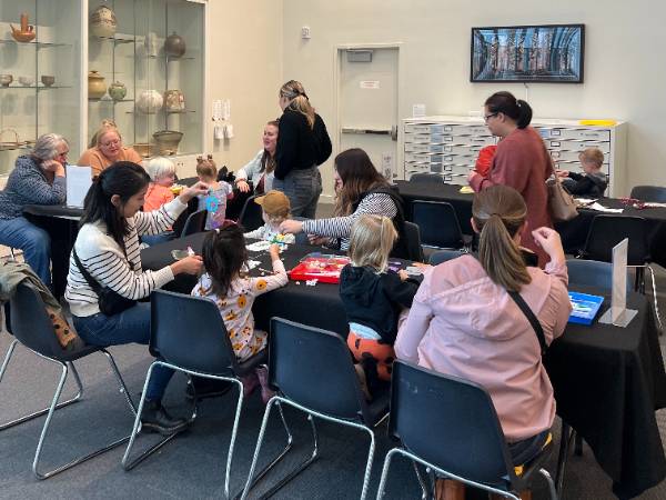 Small group mini-makers class of parents, care givers and children.