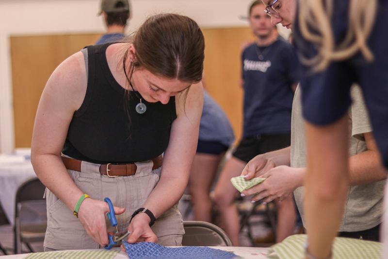 Students cutting fabric.