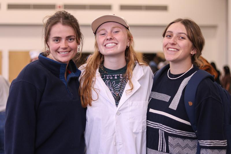 Three students smiling.