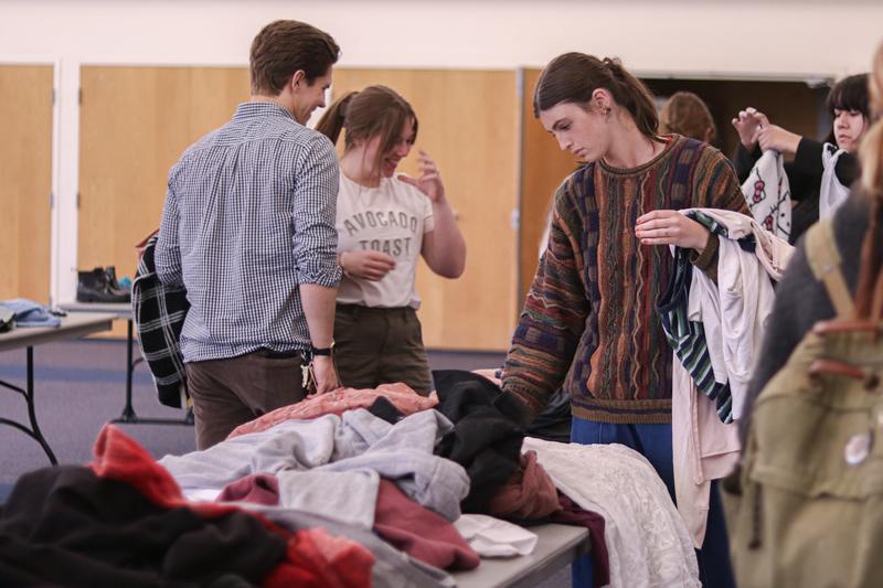 Students looking through clothes.