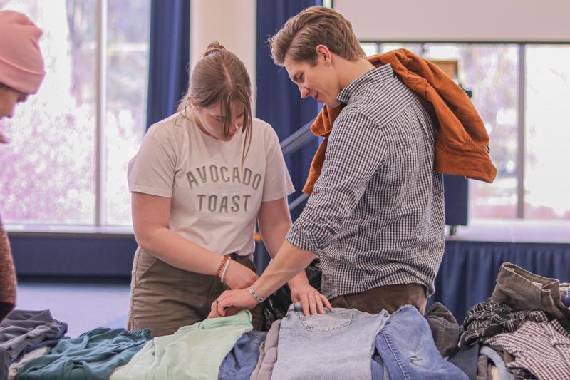 Students looking through clothes.