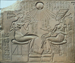 Akhenaten and Nefertiti holding their daughters (click to see larger image)