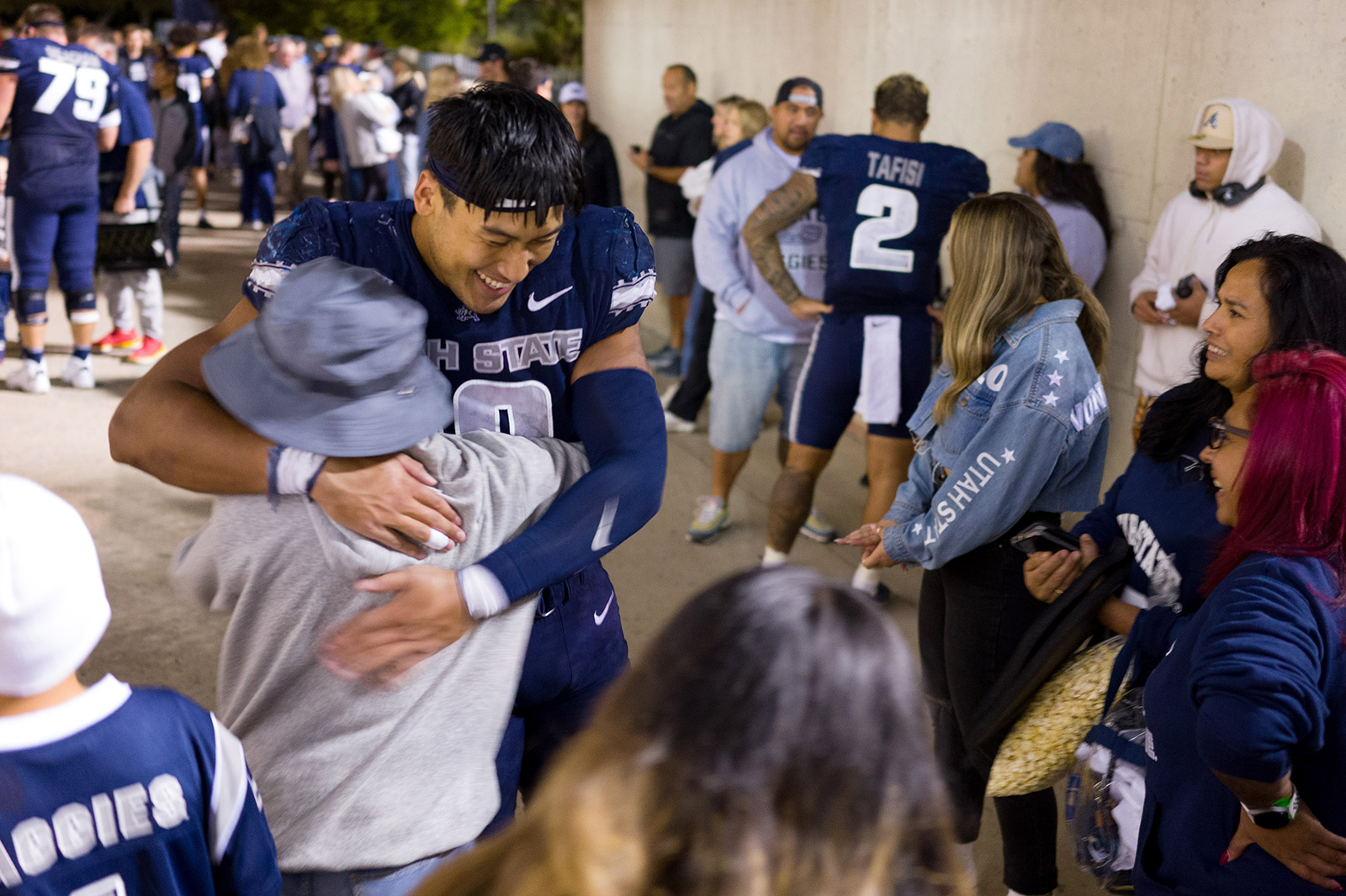 football player hugs fan
