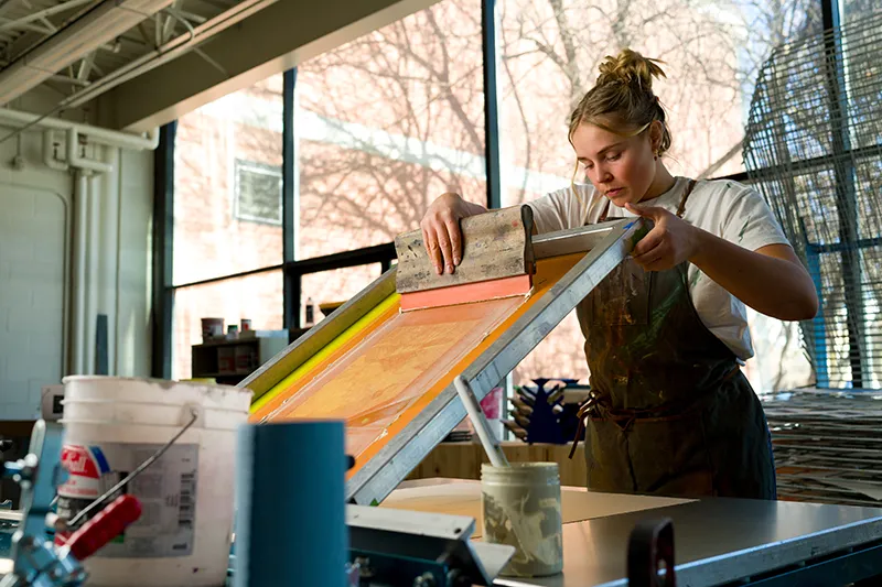 student working on art in the studio