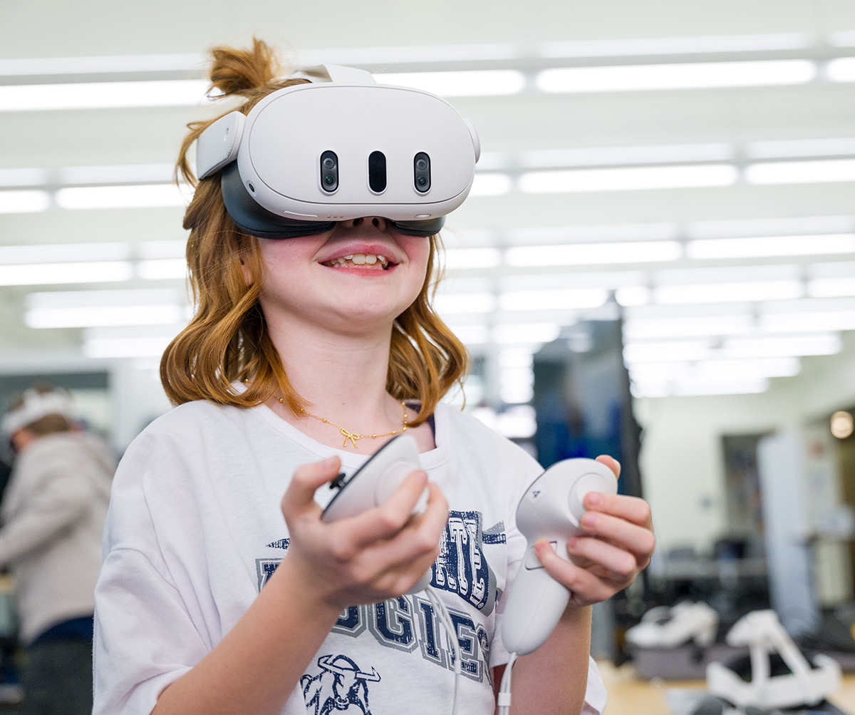 a little girl smiling while in a vr headset