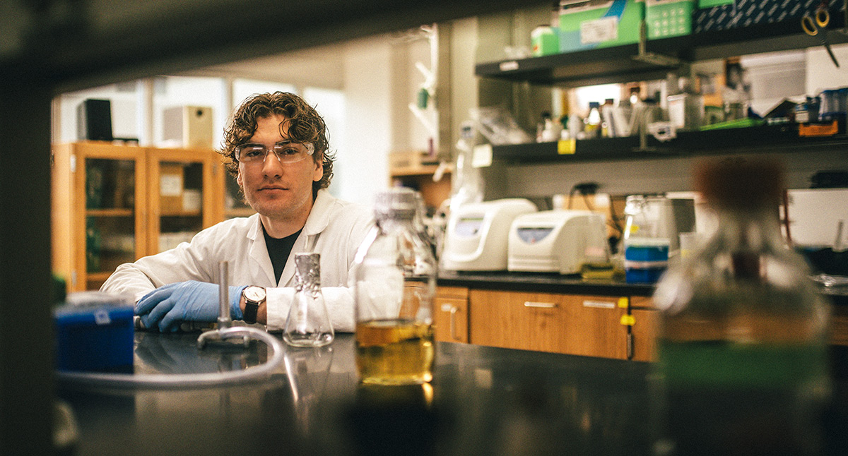 student in lab looking at camera