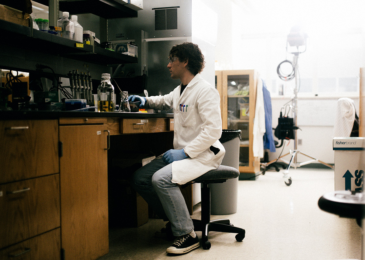 student in lab looking at notes