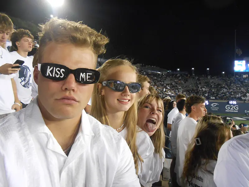 Students watching a game at the Romney stadium