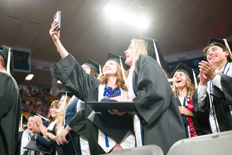 Students taking a selfie during graduation