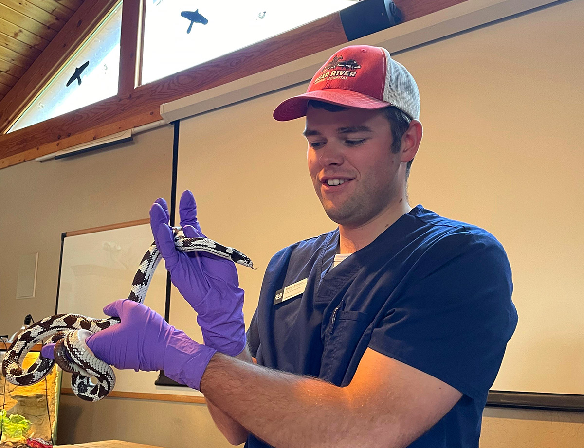 student holding a snake
