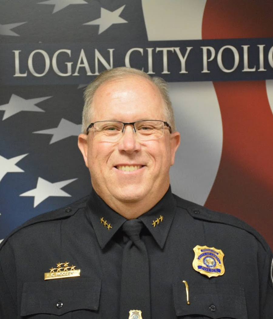 Curtis Hooley, a man in uniform and glasses, smiling at the camera.